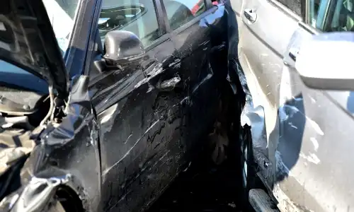 Two vehicles in an accident with each other having damaged their doors.