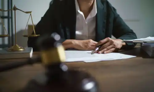 A personal injury lawyer with an out of focus gavel and soundblock in the foreground.