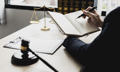 A personal injury lawyer going through notes in preparation to assist a client with an insurance claim.